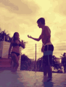 a man and a woman standing in a pool