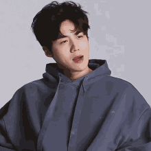 a young man wearing a blue hoodie with the letters ow on it