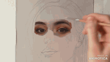 a person is painting a woman 's face with a brush and the words made in animotica are on the bottom