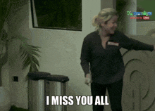 a woman says i miss you all in front of a garbage can