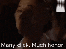 a close up of a man 's face with the words many click much honor behind him