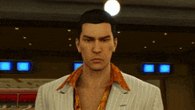 a man in a striped suit and orange shirt stands in front of a bowling alley with a bowling alley in the background