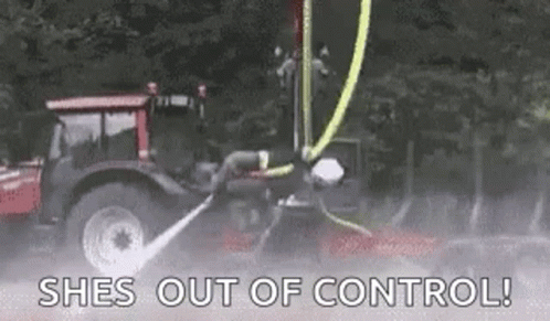 GIF of a firefighter riding a high pressure water hose which causes them to hover and spin above the ground from the force.
