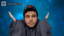 a man with his arms outstretched in front of a blue background with doublecat written on it