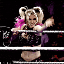 a woman in a wrestling ring with a w logo on her cap