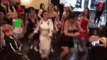 a group of women are dancing together in a room .