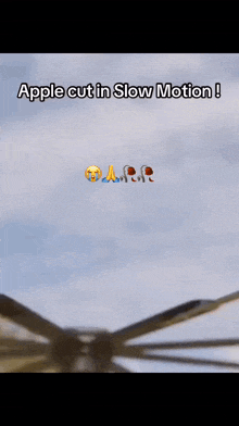 an apple is being cut in slow motion on a blade