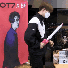 a man holding an umbrella in front of a sign that says ot7xbf