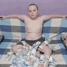 a boy is laying on a couch surrounded by russian money with a bill that says 5000