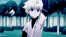 a young boy with white hair and blue eyes is holding a yo-yo