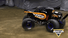 a monster jam truck is driving down a dirt road