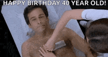a man is getting his chest waxed by a woman who is 40 years old .