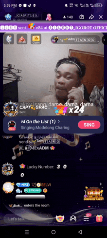 a phone screen shows a man singing a song called on the list
