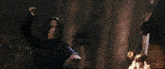 a woman in a dark room is holding a wand in her hand