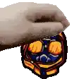 a hand is holding a cartoon character 's head with a mask on it .