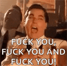 a man in a suit and tie is yelling at someone .