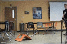 a classroom with chairs and a projector screen that says j.j.am