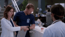 a man in scrubs is talking to a woman in a lab coat and says " why "