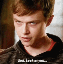 a close up of a man 's face with the words god look at you