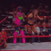 two women are wrestling in a ring with the word tringlow on the bottom right