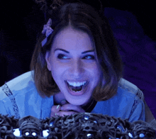 a woman with a bow in her hair is laughing