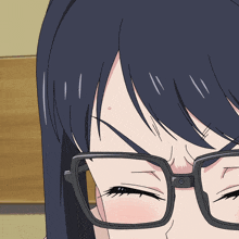 a close up of a girl wearing glasses with a bug on her face