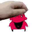 a hand is putting a red cartoon character on top of another red cartoon character .