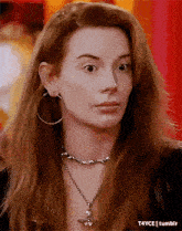 a close up of a woman wearing hoop earrings and a choker necklace