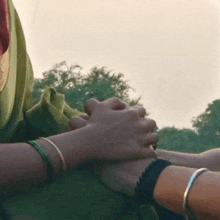 a close up of a person holding another person 's hands