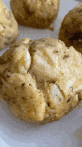 a close up of a crab cakes on a white plate