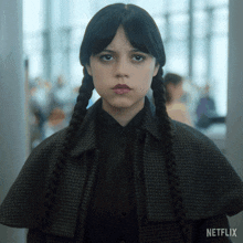 a girl with pigtails and a netflix logo in the background