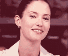 a close up of a woman 's face smiling