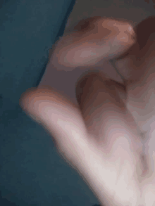 a close up of a person 's hand with their fingers extended