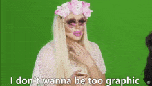 two drag queens are sitting next to each other on a green screen and one of them says i don t wanna be too graphic