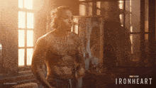 a man with a tattoo on his chest stands in front of a sign that says ironheart