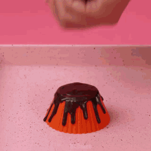 a cupcake with chocolate dripping off of it is being decorated by mr. cakes