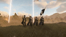 a group of people standing in a field with one holding a flag with a skull and crossbones on it