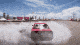 a red car is drifting in front of a sign that says hall of fame leadership
