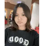 a girl wears a black shirt that says good