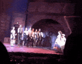 a group of people standing on a stage in a theater