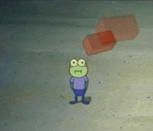 a cartoon character from spongebob squarepants is standing on a sandy beach next to a red box .