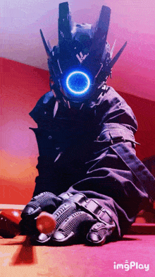 a person wearing a robot costume and gloves is sitting on a table with imgplay written below them