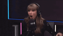 a woman wearing headphones speaking into a microphone that says bbc radio