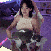 a woman sitting in a chair with a cat on her lap with the letters xg on the bottom