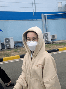 a person wearing a mask and a hoodie that says almost