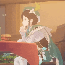 a girl with a flower on her hat is sitting at a table in a room