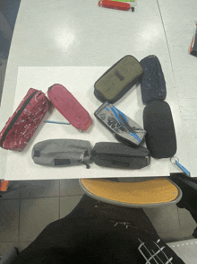 a bunch of pencil cases on a table with one that says star wars on it