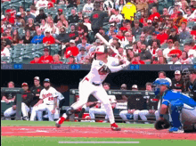 a baseball player swings his bat at a pitch in front of a crowd with a banner that says carefirst