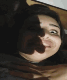 a woman with a nose ring looks at the camera