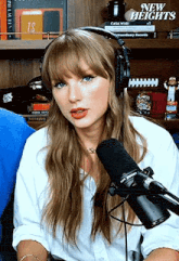 a woman wearing headphones and a microphone is talking into a microphone .